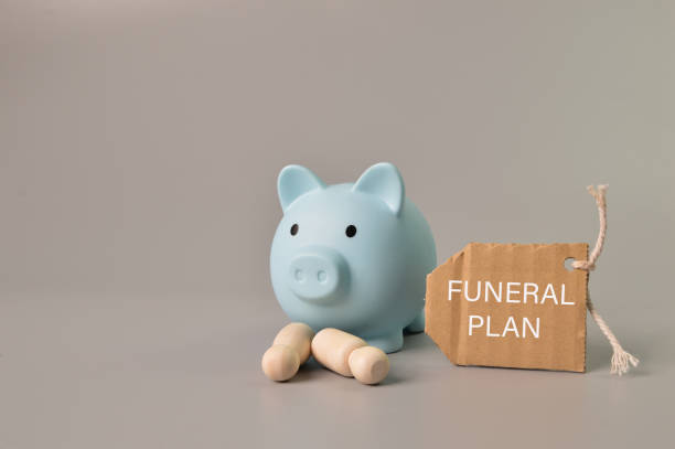 Piggy bank, people figures and label tag written with FUNERAL PLAN Piggy bank, people figures and label tag written with FUNERAL PLAN